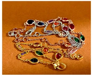 Detail of colorful gemstone bracelets in gold and silver finishes with lobster clasp