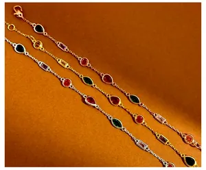 Detailed macro view of three dainty bracelets with multicolored drop and marquise gems