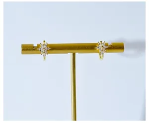 Close-up of gold-plated flower hoop earrings with sparkling marquise-cut crystals