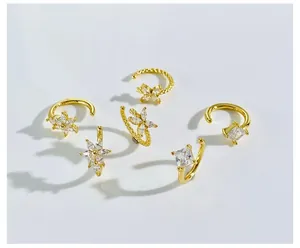 Detail of 6pcs gold ear cuff set with star, square and floral cubic zirconia designs