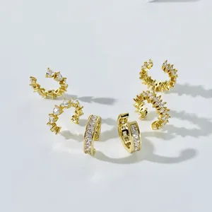 Three-piece gold plated earring set with marquise cut cubic zirconia on a white background