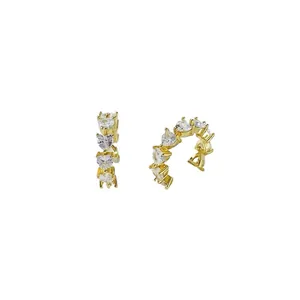Golden C-shaped earrings with heart-shaped white zircons in a romantic design