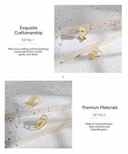 Detailed view of gold brass clip earrings with opal stone on a white stone background