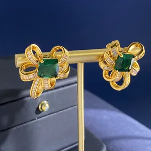 Ohrstecker mit smaragdgrünen Zirkonia-Schleifen in Goldoptik und glänzenden Akzenten