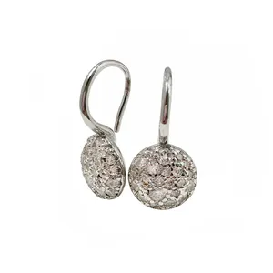 Close-up of silver drop earrings featuring a circular disc with pave set cubic zirconia stones