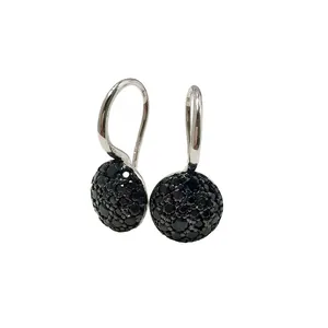 Detailed macro view of silver hoop earrings featuring micro-pave set black gemstones