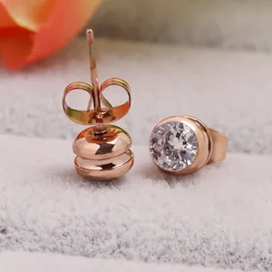 Macro shot of rose gold titanium steel stud earrings with sparkling round zirconia crystal
