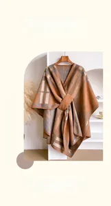 Detail of checkered cashmere scarf with ring buckle fastener and thick warm texture