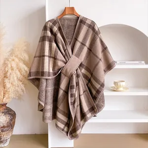 Detail of a brown and beige plaid shawl on a hanger with minimalist Nordic decor