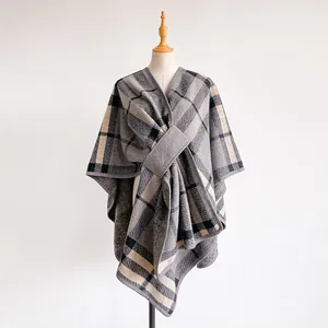 Detail of grey and beige plaid shawl featuring a wrap design and matching fixed belt tie