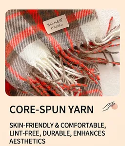 Detail of core-spun yarn texture and tassel fringe on an orange plaid scarf