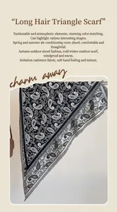 Detailed close-up of paisley pattern fringe edge on black and white pashmina scarf