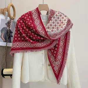 Close-up of red and white geometric diamond jacquard texture with fringe detailing