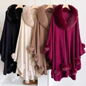Close-up of winter knit shawls with faux rabbit fur collars and pom-poms in four colors