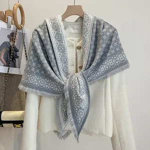 Close-up of minimalist diamond jacquard scarf with fine fringe on tweed jacket