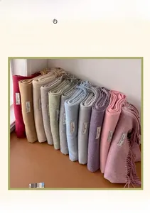 Detailed view of colorful wool blend scarves with tassels and fabric composition labels