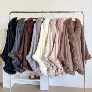 Selection of oversized loose ponchos with faux rabbit fur trim in various neutral colors