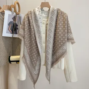 Close-up of geometric diamond pattern jacquard scarf with elegant fringe texture