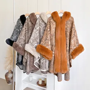 Macro detail of paisley patterns and thick faux fur trim on winter poncho cape