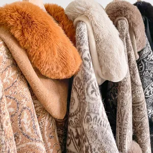 Detail of winter paisley poncho featuring thick faux fur collar and jacquard knit fabric