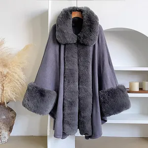 Detailed view of luxury dark grey faux fur collar and cuffs on a winter poncho coat