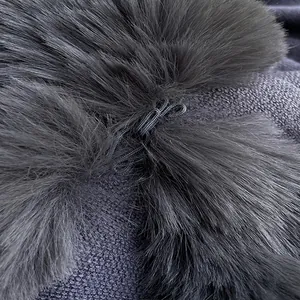 Macro detail of dark grey faux rabbit fur collar with elastic loop on knitted coat