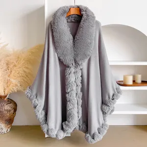 Macro shot of plush faux rabbit fur trim and premium grey knitted fabric on a long cape