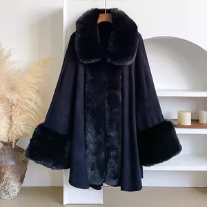 Detail of luxury black cape with thick faux fur trim and warm wool-like fabric texture