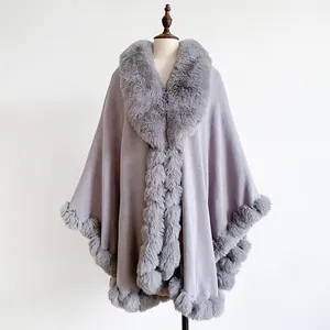 Close-up of lilac oversized shawl with plush faux rabbit fur trim on soft wool fabric