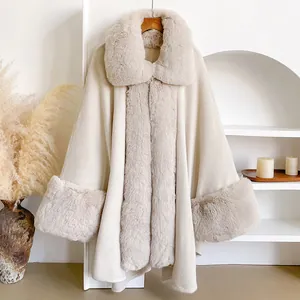 Detailed view of the luxury beige faux fur collar and trim on a soft knitted winter cape
