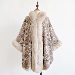 Detail of winter paisley poncho with faux fur trim on the collar and knit texture