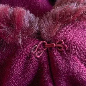 Women's burgundy knit poncho with faux rabbit fur collar and elegant knot clasp closure
