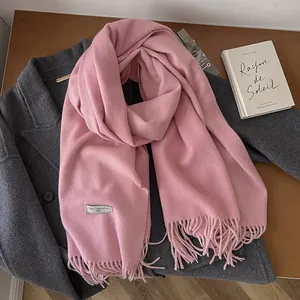 Detailed macro view of pure wool scarf fringes and material composition label