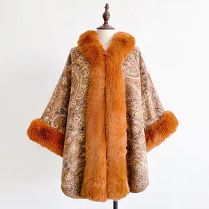 Detail of winter paisley poncho with orange faux fur collar and thick woven texture
