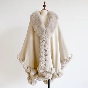 Macro shot of fluffy faux rabbit fur collar and knit texture on the beige shawl