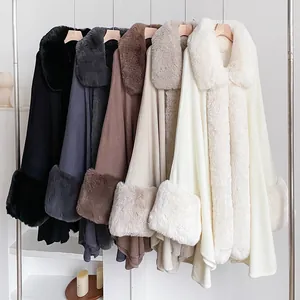 Luxury faux fur trim cloaks in grey, black, and beige colors hanging on a metal rack