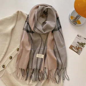 Detailed texture of British style wool blend plaid scarf with elegant fringe and tag