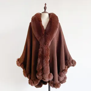 Detail of faux fur collar and thick woolen fabric on dark brown oversized cape shawl