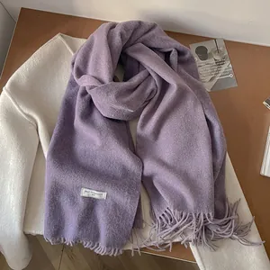 Detailed macro view of soft lavender 100% wool scarf texture and classic fringe tassels