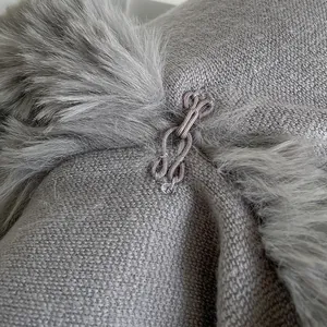 Oversized poncho with faux rabbit fur collar and detailed metal hook closure
