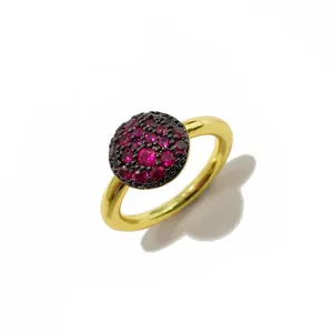 Macro d'une bague dorée de luxe avec pierres rouges et base en rhodium noir vintage