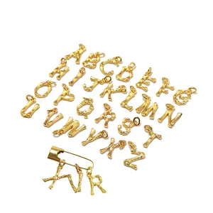 26 gold alphabet charms with safety pin featuring elegant bamboo textured metal finish
