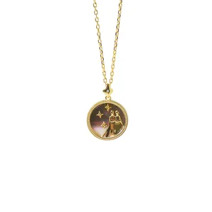 Close-up of golden Gemini zodiac necklace with dark shell inlay and milgrain edge detail