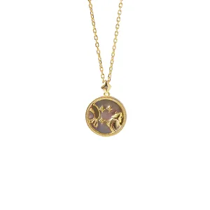 Macro detail of gold Pisces zodiac pendant with iridescent grey mother of pearl inlay