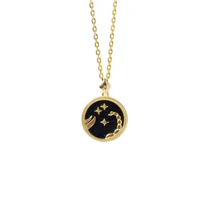 Detailed close-up of golden Scorpio necklace with black starry base and intricate engraving