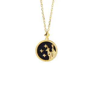 Detail of golden constellation necklace with starry blue pendant and star motifs