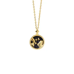 Macro shot of gold coin pendant featuring blue starry sky and Pisces constellation detail