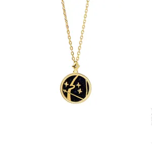 Close-up of Sagittarius star sign pendant with golden bow on a blue glitter background