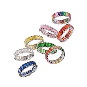 Close-up of rainbow baguette cut eternity rings with colorful zircon in silver settings