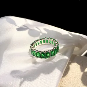 Detail of S925 sterling silver ring featuring full baguette cut green emerald zircons